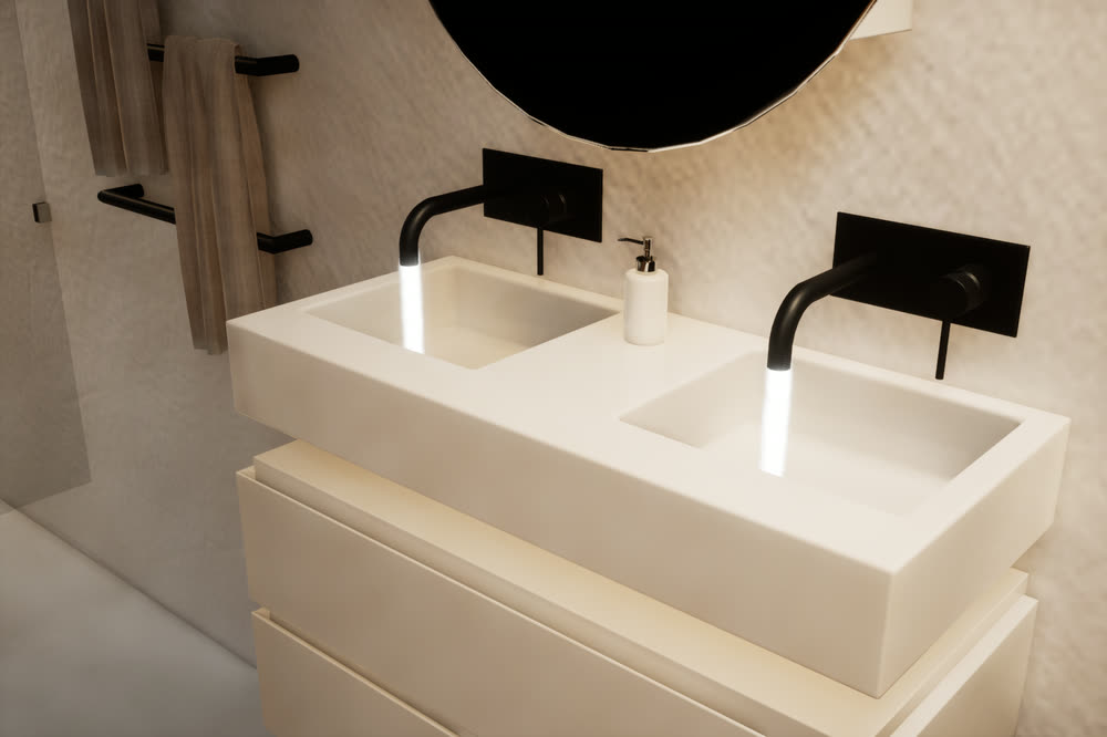 Double basin in white stone with black wall-mounted taps, both running.