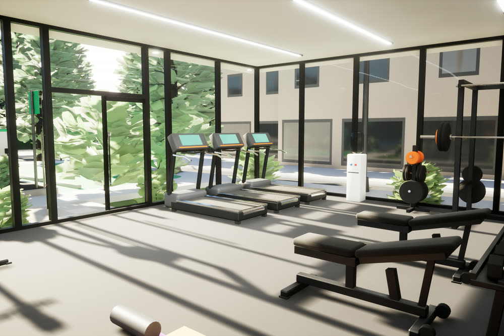 Inside the glass gym pavilion: treadmills, a weight bench and dumbbells, with full-height windows onto trees.